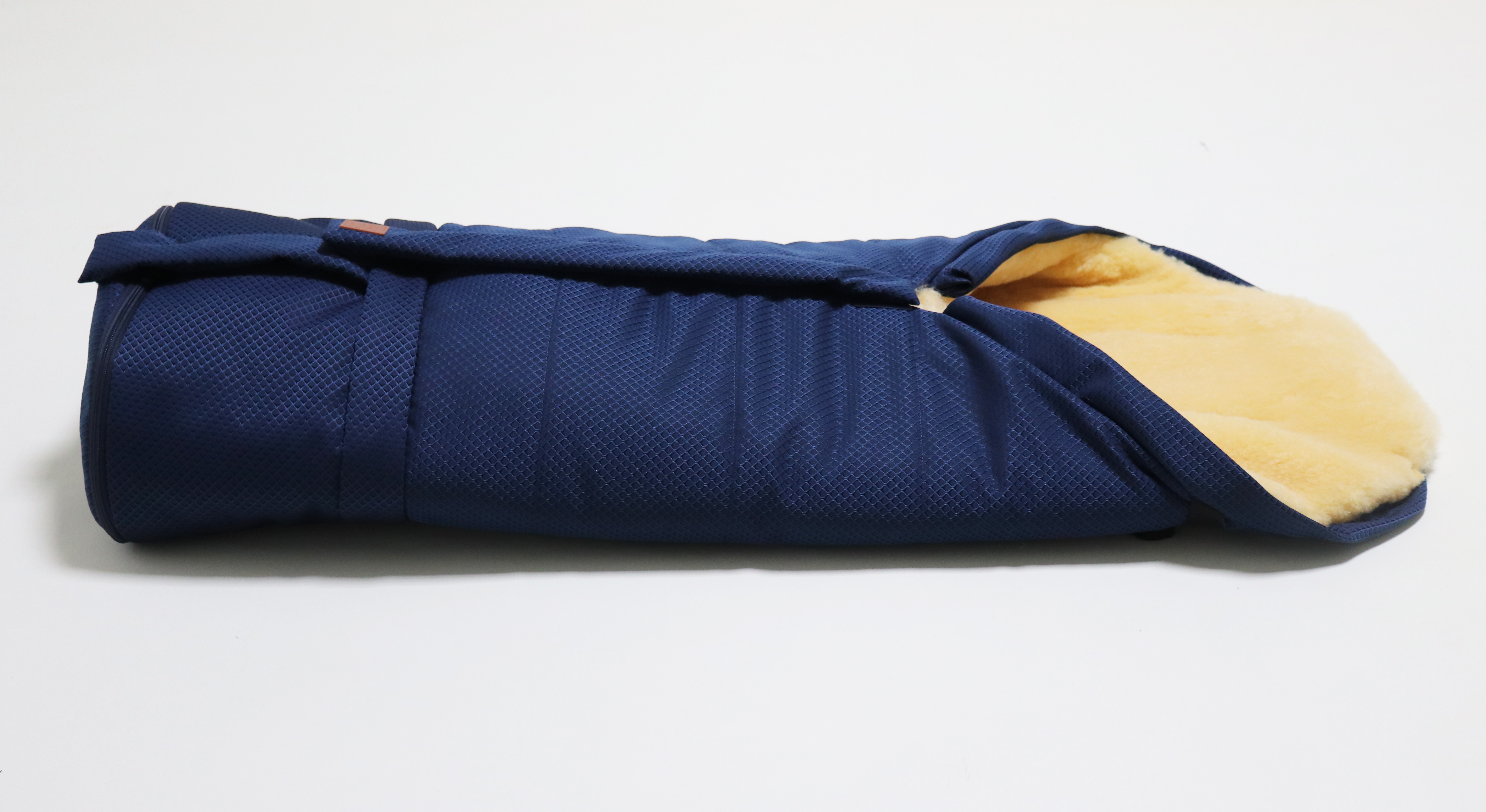 Fußsack mit dem Lammfell-Innenfutter in der Farbe blue waffle liegt horizontal