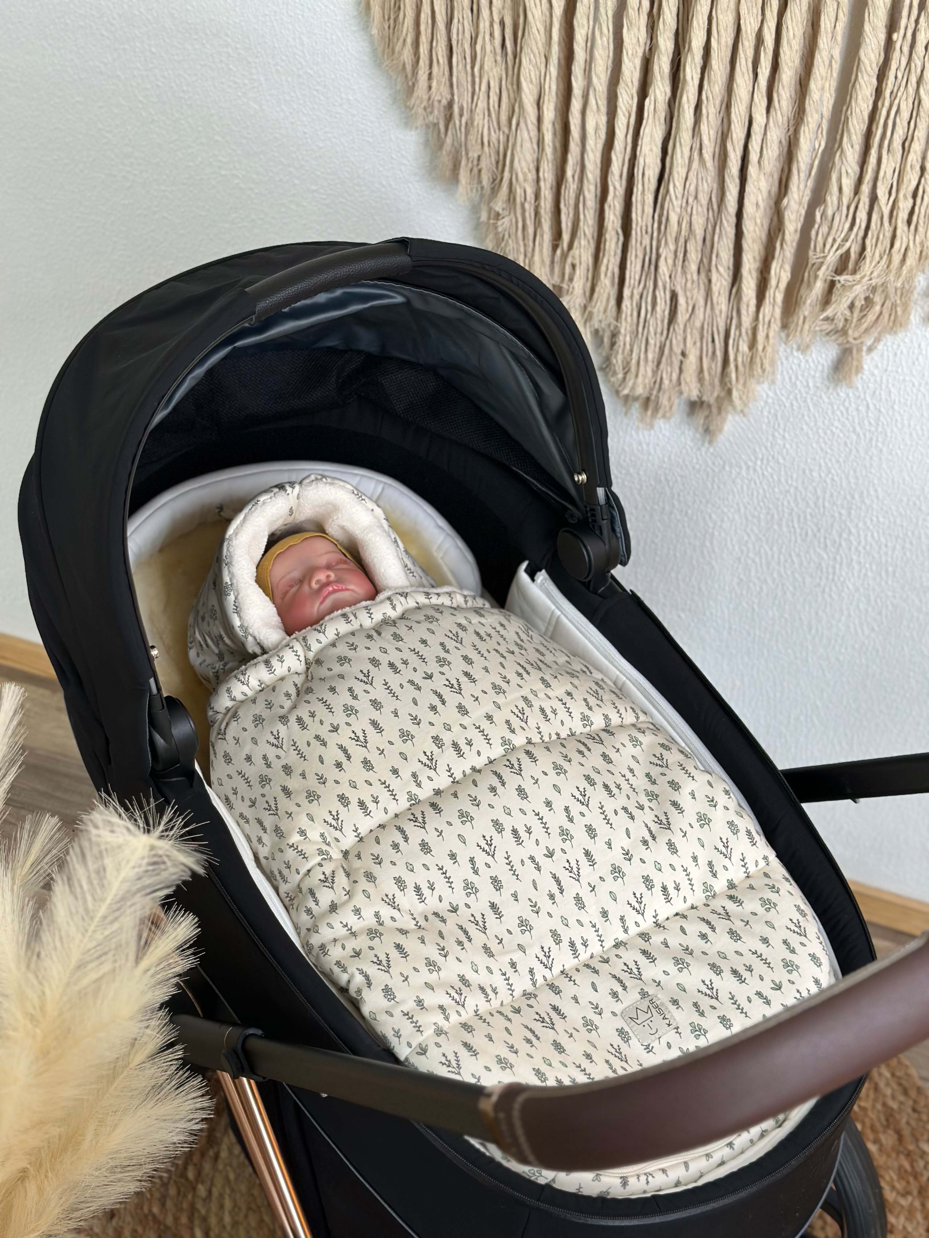 Baby in Babyschale mit Kaiser Jersey Hood Winter in der Farbe leave mit abnehmbarem Oberteil