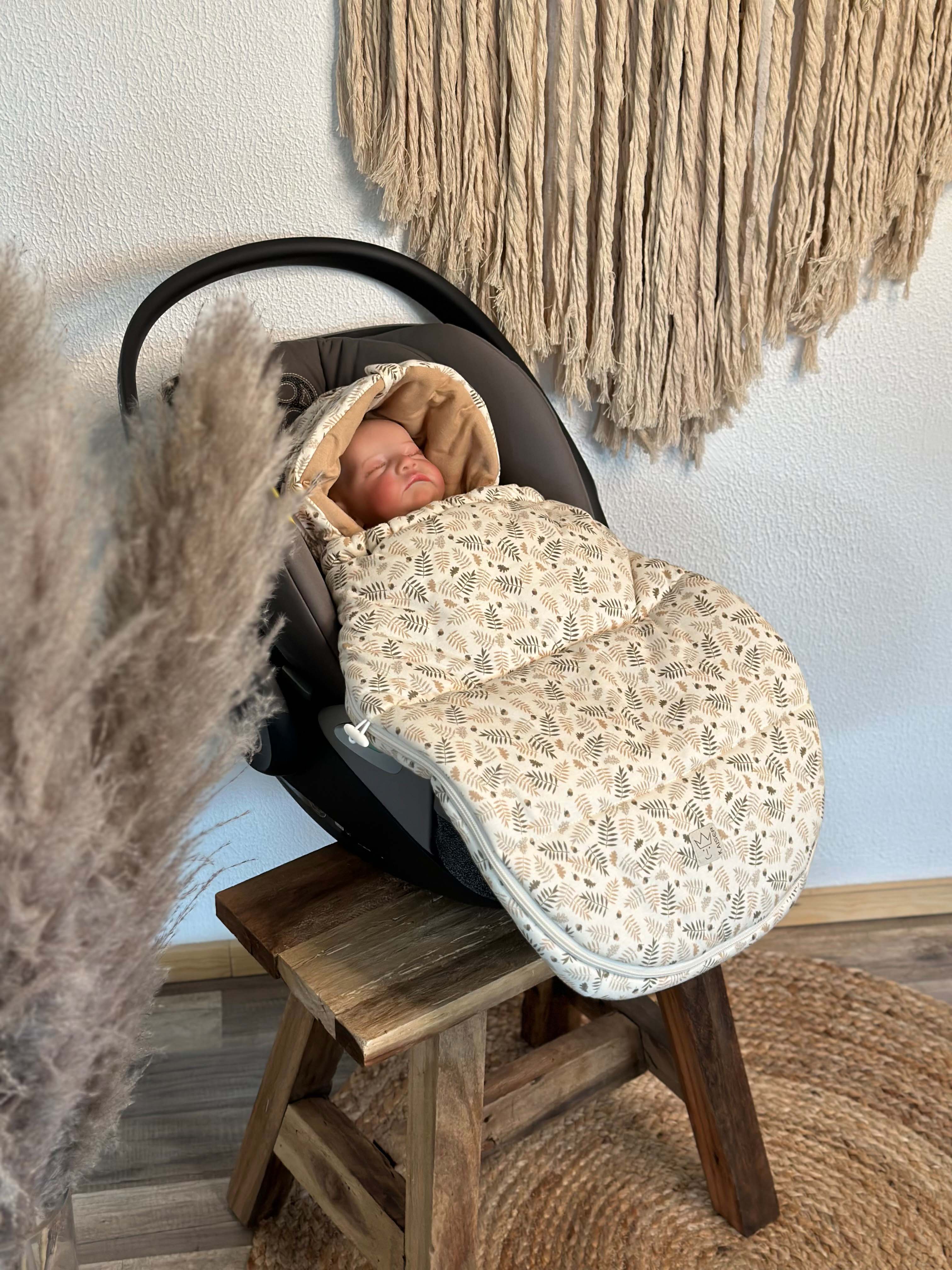 Baby im Autositz mit SMALL JERSEY HOODED Babyschalen Fußsack in der Farbe  forrest cream